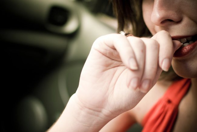 Woman biting her nails